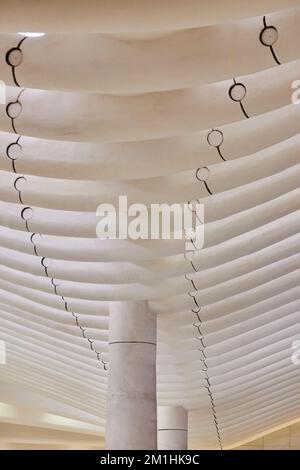 Interior clean white subway ceiling with ribs crossing horizontally into distance Stock Photo