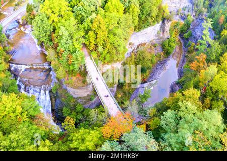 Aerial over large gorge with waterfall and bridges crossing over Stock Photo