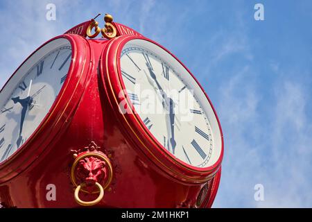 Detail of red clock with blue sky in Bloomington Indiana University Stock Photo
