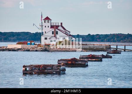 Foundations for bridge empty leading to small island with white house Stock Photo