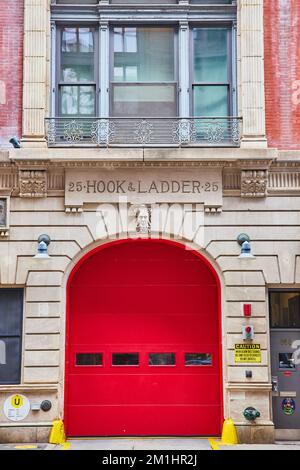 New York City outside fire station 25 Hook and Ladder with huge red door straight on Stock Photo