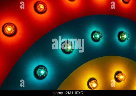 Detail of light bulbs on rainbow wave of red, blue, and yellow Stock Photo