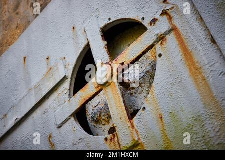 Rusting air vent on steel door to abandoned mine Stock Photo