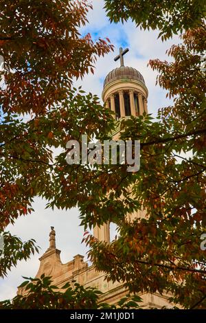 Christian Church steeple through fall trees in New York City Stock Photo