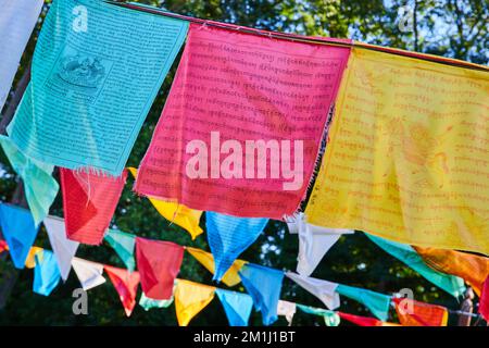 Rows of vibrant prayer flags for Tibetan Mongolian Buddhist shrine Stock Photo