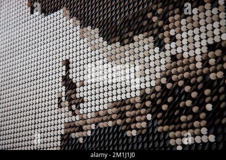 Wall of white and black flipping pieces blurred abstractly Stock Photo