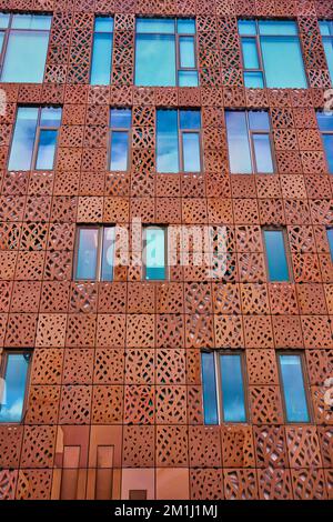 Wall of red steel with cutouts and windows in New York City Stock Photo