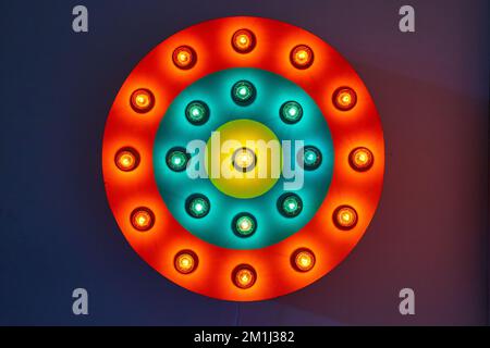 Circle red, blue, and yellow neon light on wall Stock Photo