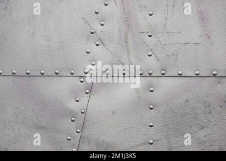 Smooth sheet metal texture asset with bolts and part of airplane Stock Photo