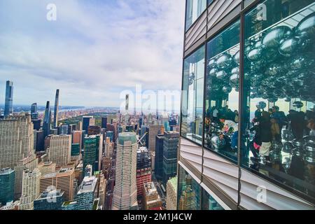 High up skyscraper outside wall and inside of metal balls with view of New York City skyline outside Stock Photo