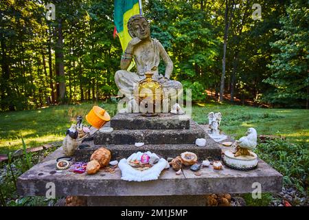 Forest with platform for small stone Tibetan Mongolian Buddhist statue and donations Stock Photo