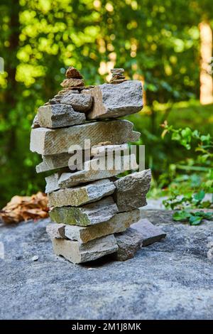 Cairn stack of rectangular rocks in forest Stock Photo