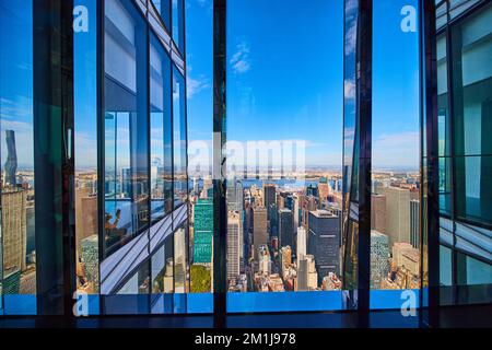 Windows high up in skyscraper from inside overlooking city Stock Photo