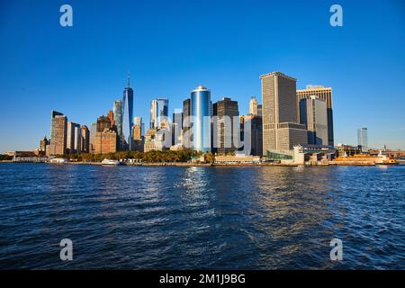Beautiful New York City skyline from the water with sunlight hitting southern Manhattan Stock Photo