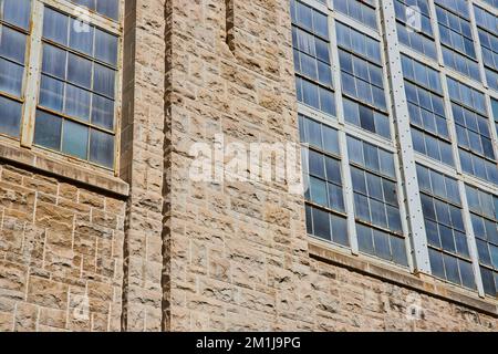 Detail of stone wall and industrial building windows Stock Photo