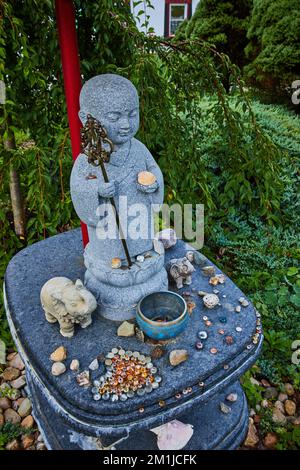 Statue with small donations for Tibetan Mongolian Buddhist zen and meditation  Stock Photo