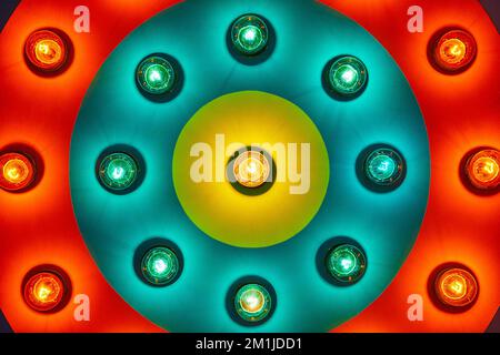 Detail of light bulbs on circular piece with red, blue, and yellow rings Stock Photo