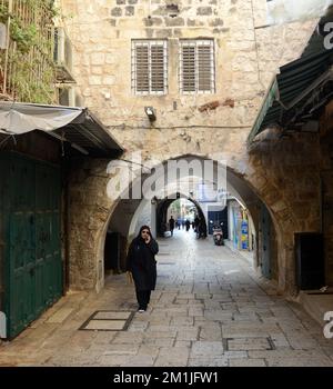 A Palestinian woman walking in the Muslim quarter in the old city of Jerusalem. Stock Photo