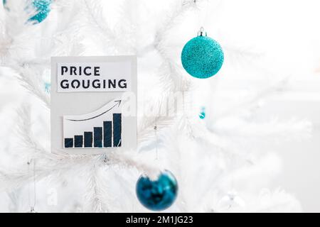 Price Gouging text and graph with growing stats in front of Christmas tree with decorations, concept of the post pandemic economy in witner 2022 Stock Photo
