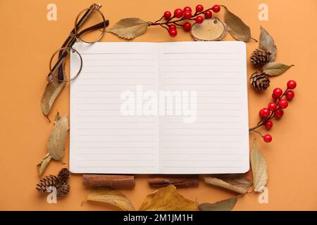 Composition with blank notebook, eyeglasses and natural forest decor on color background Stock Photo