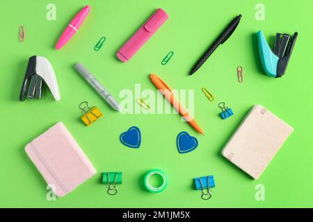 Composition with different stationery on green background Stock Photo