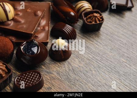 Chocolate bars and candies on wooden background Stock Photo
