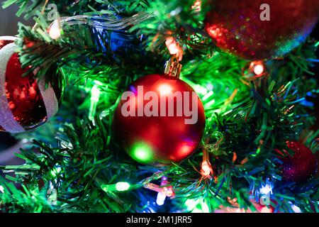 A red bauble on Christmas tree Stock Photo