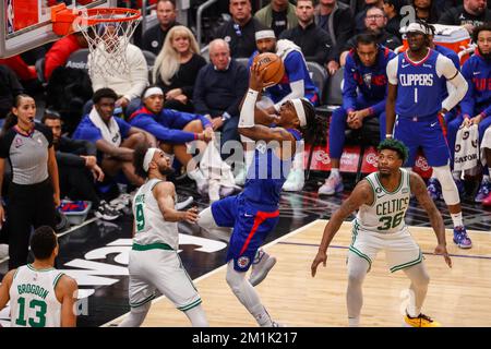 Los Angeles, California, USA. 12th Dec, 2022. Los Angeles Clippers guard Terance Mann (14) shoots over Boston Celtics guard Derrick White (9) during an NBA basketball game Monday, December 12, 2022, in Los Angeles. (Credit Image: © Ringo Chiu/ZUMA Press Wire) Stock Photo