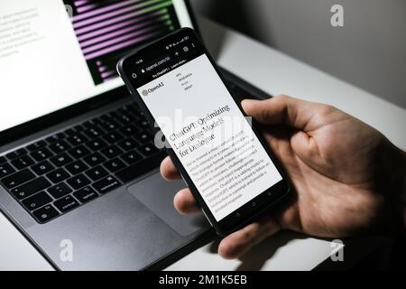 Screen with ChatGPT chat with AI or artificial intelligence. Man search for information using artificial intelligence chatbot developed by OpenAI Stock Photo