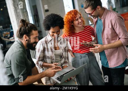 Smiling diverse colleagues gather in boardroom brainstorm discuss financial statistics together Stock Photo