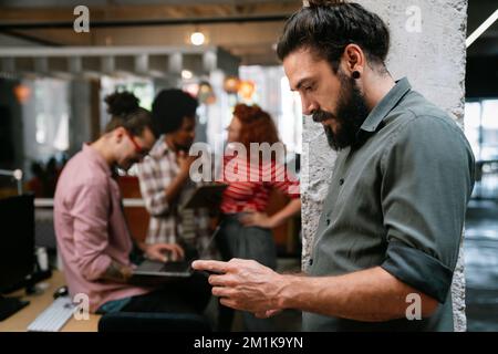 Programmers cooperating at IT company developing apps. People business work office concept Stock Photo