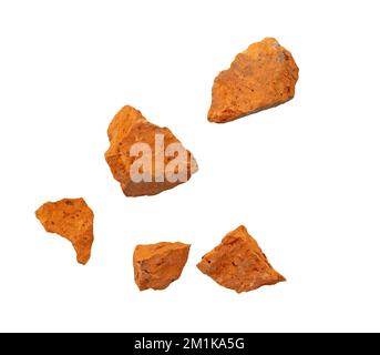 Falling flying pieces of broken red brick isolated on white, clipping path Stock Photo