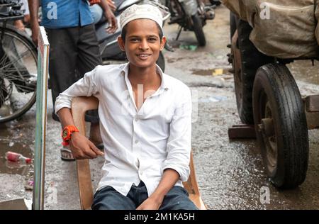NEW DELHI - SEP 17: Portrait of unidentified cheerful boy sitting at the Main Bazar of New Delhi on September 17. 2022 in India. Stock Photo