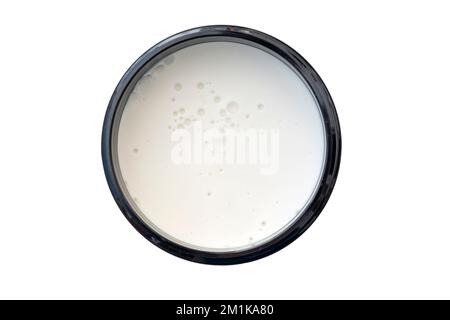 Cosmetic cream, wax, mousse in round black container isolated on white, top view Stock Photo