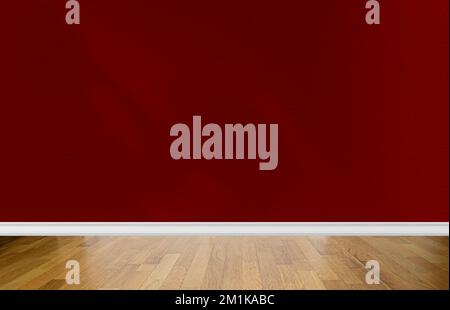 Interior of a room with blank red wall, abstract shadows and pine parquet floor. Space for text Stock Photo