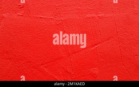 Part of wall with rough red paint on surface, as texture or background Stock Photo