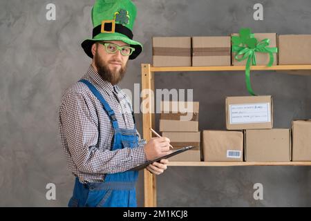 Young delivery man with parcel box in outdoor context with ppe