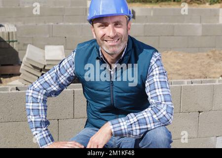 construction worker posing with bricks on white Stock Photo