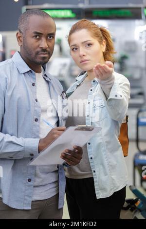 workers in warehouse preparing goods for dispatch Stock Photo