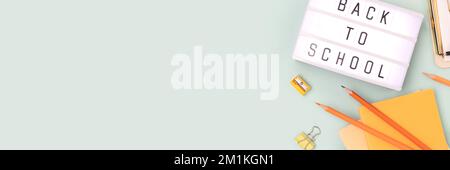 Back to school. Banner with lightbox with letters and stationery on a blue pastel background. Place for text. Stock Photo