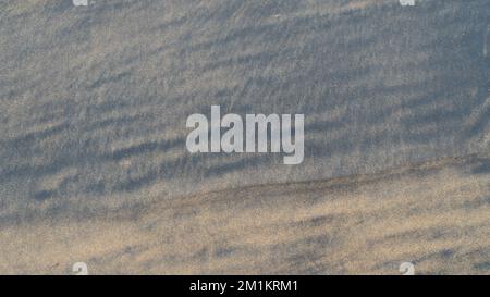 Black and brown sea sand close-up background Stock Photo