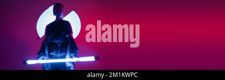 abstract silhouette of blurred woman with neon lamps on purple and red background, banner,stock image Stock Photo