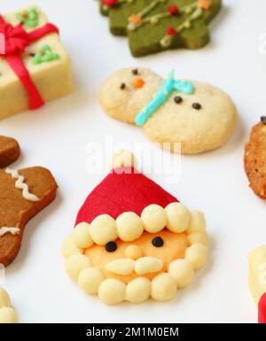 Closeup of Santa Claus with Another Christmas Cookies Scattered on White Background Stock Photo