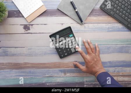 top view of man hand using calculator Stock Photo