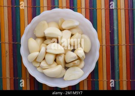 top view of slice of garlic in a bowl on table  Stock Photo