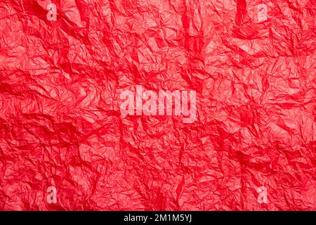 Empty red crumpled silk paper background, lot of copy space. Studio shot. Stock Photo