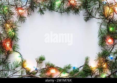 Christmas frame with Christmas ornaments and decorations. Garland on the Christmas tree. Square frame White. Stock Photo