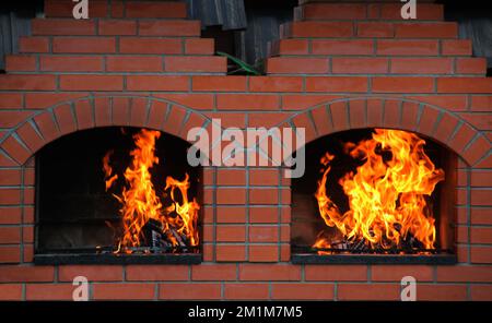 Wood Logs Burning In A Double Brick Oven Stock Photo