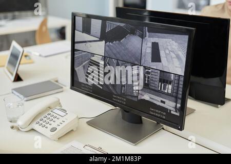 Background image of surveillance camera feed in black and while on monitor in security center Stock Photo