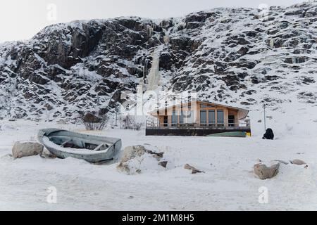 Abandoned wooden cottages up high in the mountains in winter Stock Photo
